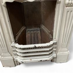 Two Victorian small cast iron fireplaces in a white finish