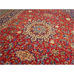  Large Persian Kashan rug carpet, large central rosette medallion on red ground field surrounded scrolling foliate, shaped spandrels with flower head motifs, repeating five banded border, 570cm x 330cm  