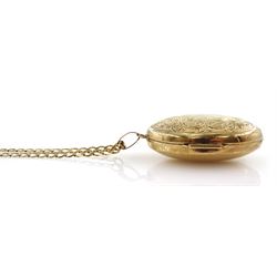 Gold locket pendant necklace, with engraved foliate decoration, on gold flattened curb link chain necklace, both 9ct