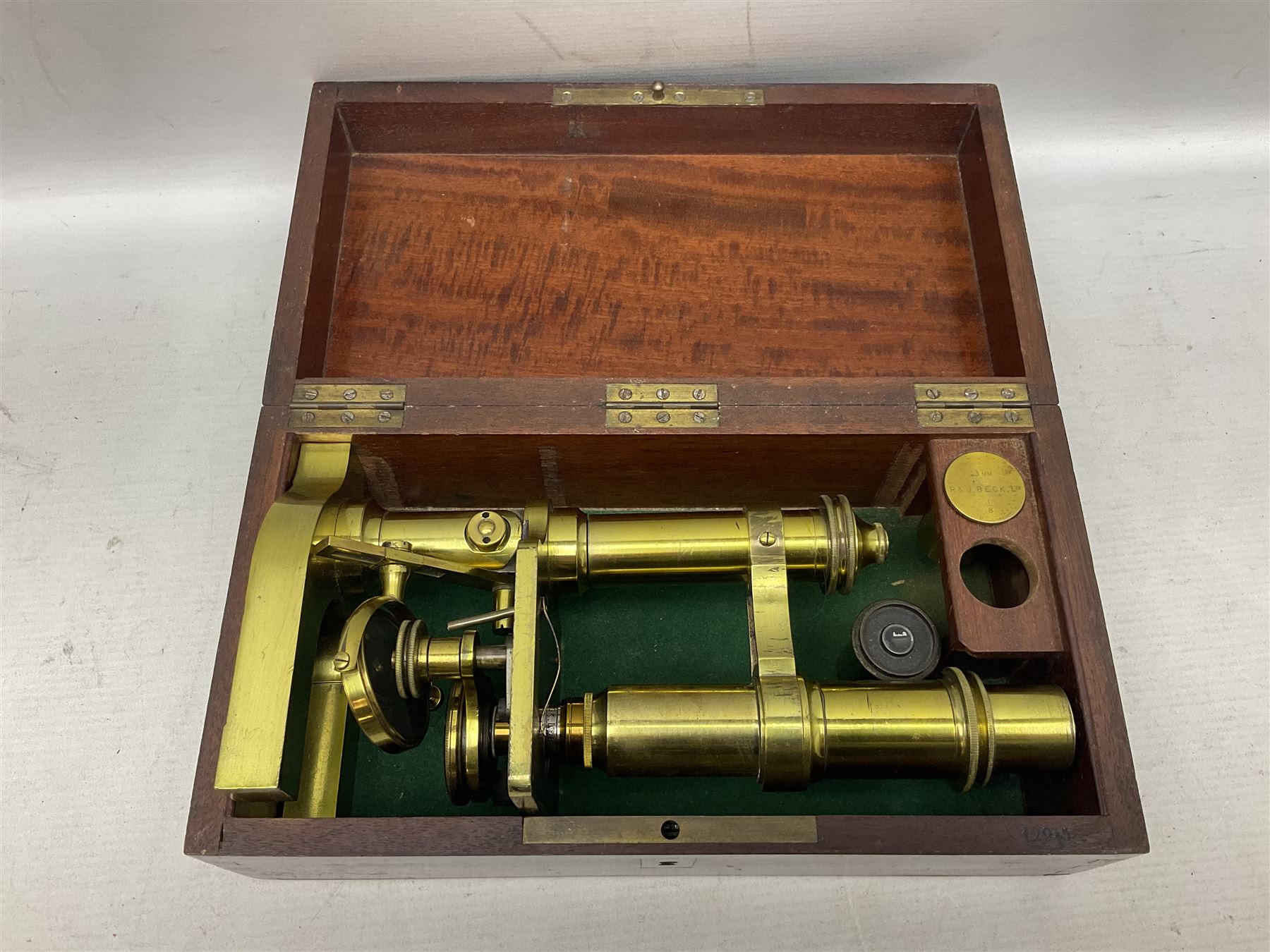 19th century brass monocular microscope by R. & J. Beck London No.18760 with hinged column and pitchfork base H25cm; in fitted mahogany case with two lenses