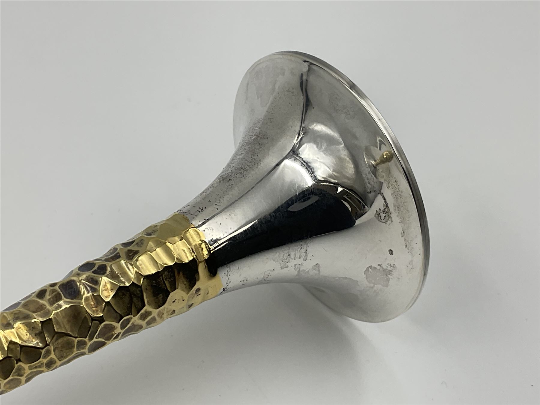 Pair of modern silver candlesticks by Stuart Devlin, the tapering parcel gilt stems with signature textured detailing, each supporting a fluted candle holder and upon a spreading circular foot, hallmarked Stuart Devlin, London 1973, H25cm