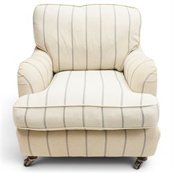 Pair of 20th century Howard shape armchairs, deep seat armchairs in cream and grep striped upholstery, raised on dark supports terminating in front castors