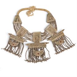 Collection of Middle Eastern jewellery, including silver necklace with a crescent  shaped pendent with beadwork and barrel tasselled ends, nickel silver wedding necklace with filigree decoration, coin bracelet, two bridal wedding caps and two others 