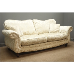 Three seat sofa upholstered in gold fabric with floral pattern, turned supports, W224cm  
