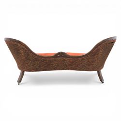 Victorian mahogany framed serpentine sofa, the shaped button upholstered back with central carved foliate cartouche, and scroll arms with carved terminals, over upholstered red seat, upon carved cabriole supports with castors