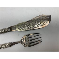 Pair of Victorian fish servers by Henry Atkin of Sheffield, the hallmarked silver handles modelled as stylised fish and reeds mounted to ornately engraved silver-plate pierced fork and knife blade, longest L33cm