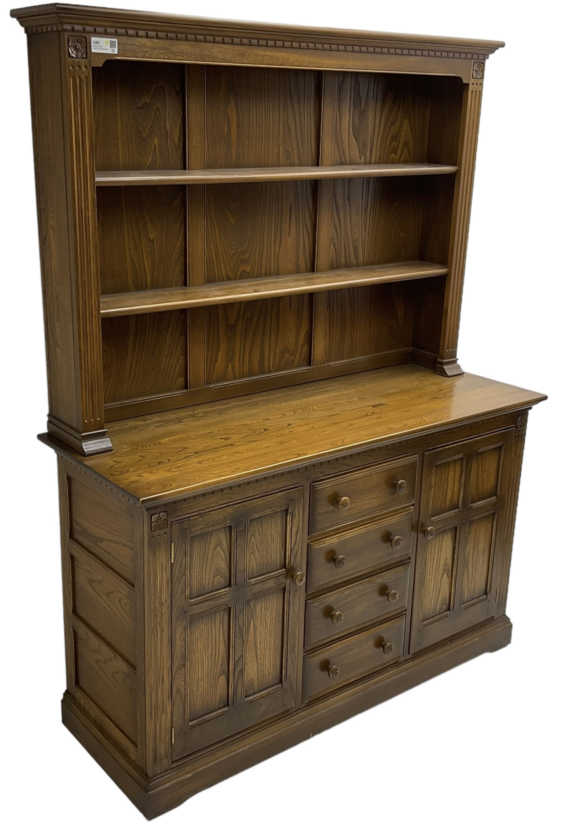 Ercol - mid-20th century dark elm 'Old Colonial' dresser, two tier plate rack with fluted uprights, base fitted with four drawers flanked by two panelled cupboards