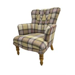 Traditional shaped armchair, upholstered in deep buttoned purple tartan fabric with red piping, raised on turned and tapering stained beech supports