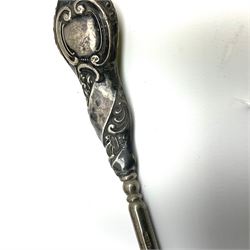 Cased silver handled glove stretcher, button hook, shoe horn, etc., hallmarked Adie & Lovekin Ltd, Chester 1911, and Adie & Lovekin Ltd, Birmingham 1911, miniature silver mounted hymn book, the cover embossed with cherubs, silver handled button hook, ivory handled button hook with silver ferrule, two silver dressing table pot lids, etc. 