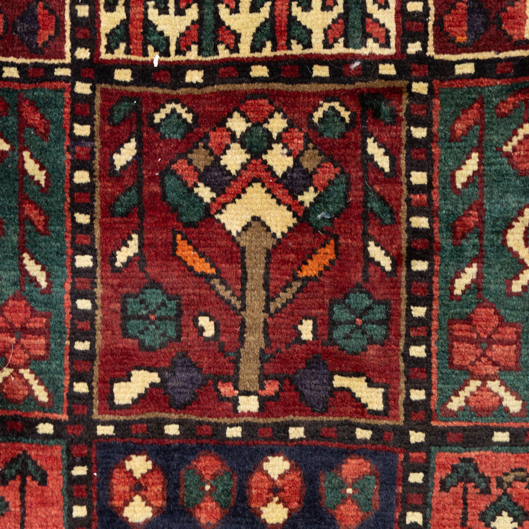 Bakhtiari wool rug, compartmented garden design field with panels of stylised trees, flowers and geometric motifs, enclosed by dark blue main border with repeating floral medallions and guard stripes