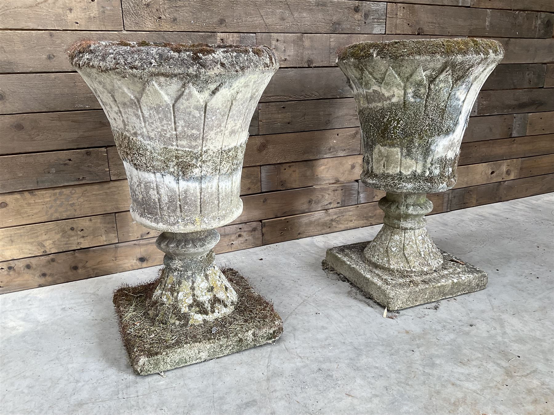 Pair of Regency design weathered cast stone garden urns