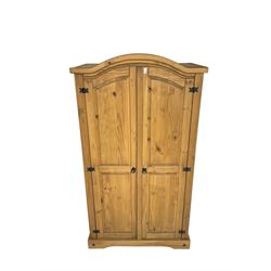 Pine double wardrobe, arched top, enclosed by two panelled doors on a plinth base