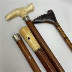 Group of walking canes, late 17th century and later, to include an example with naively carved handle modelled as a boot, another with ivory handle and unmarked white metal collar, etc. 
