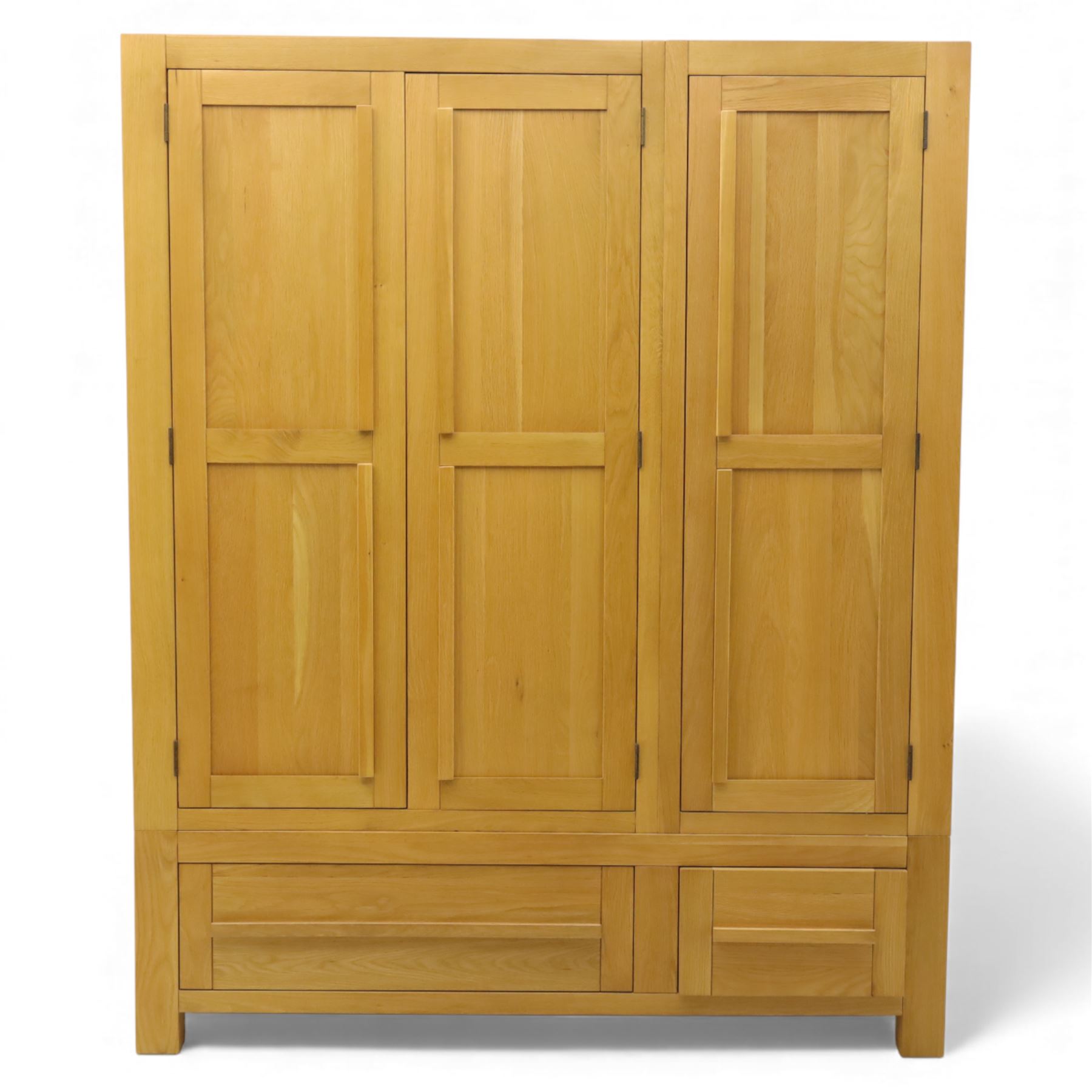 Modern light oak triple wardrobe,  three panel doors with integrated handles enclosing full-height hanging rails, the lower section fitted with two flush-front drawers, square uprights