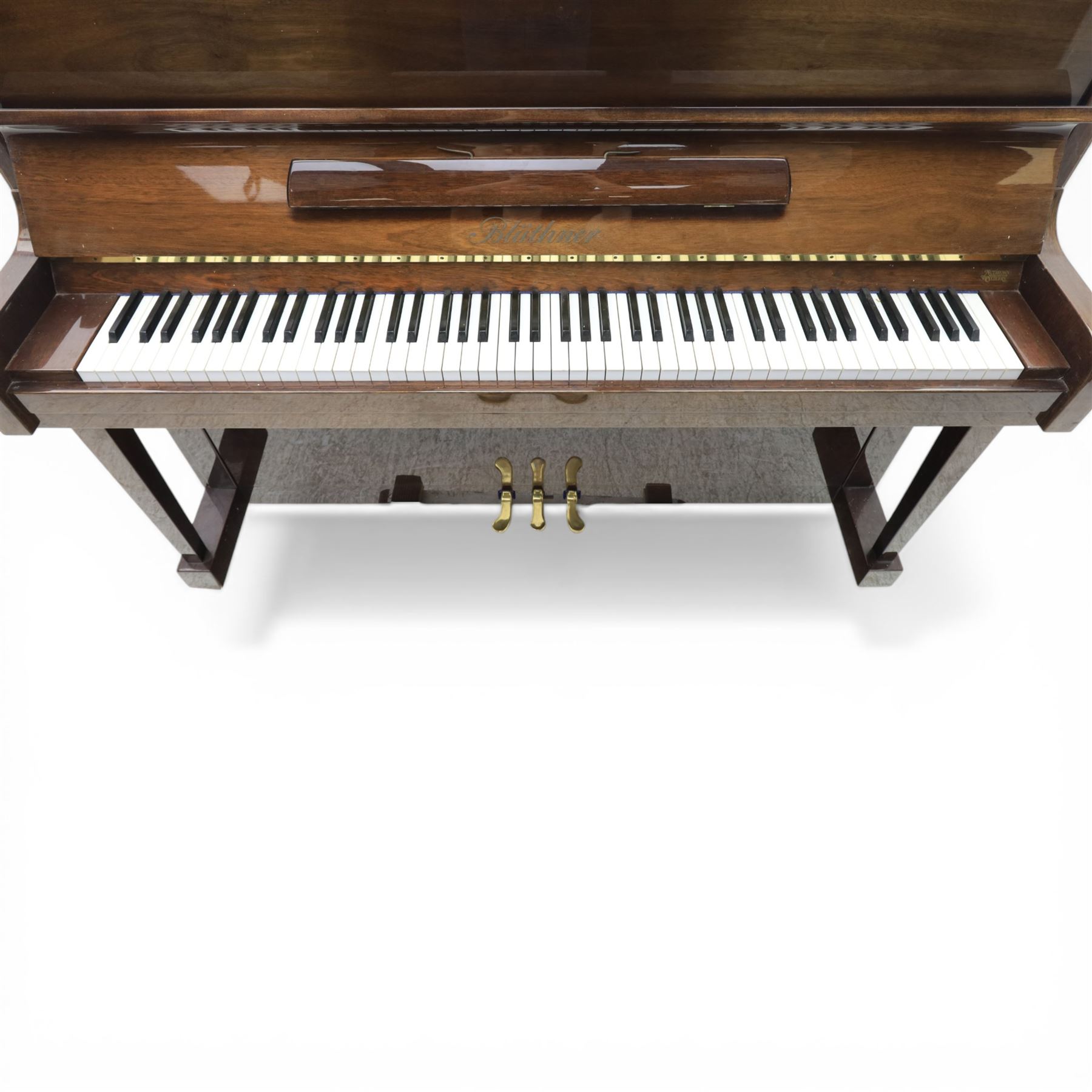 Bluthner of Leipzig upright piano, mahogany case with 88 keys and three brass pedals