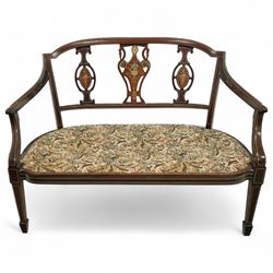 Edwardian marquetry inlaid mahogany salon settee, with bowed top rail and pierced splat back featuring central classical urn flanked by oval floral medallions, floral upholstered seat on boxwood strung square tapering legs terminating in spade feet