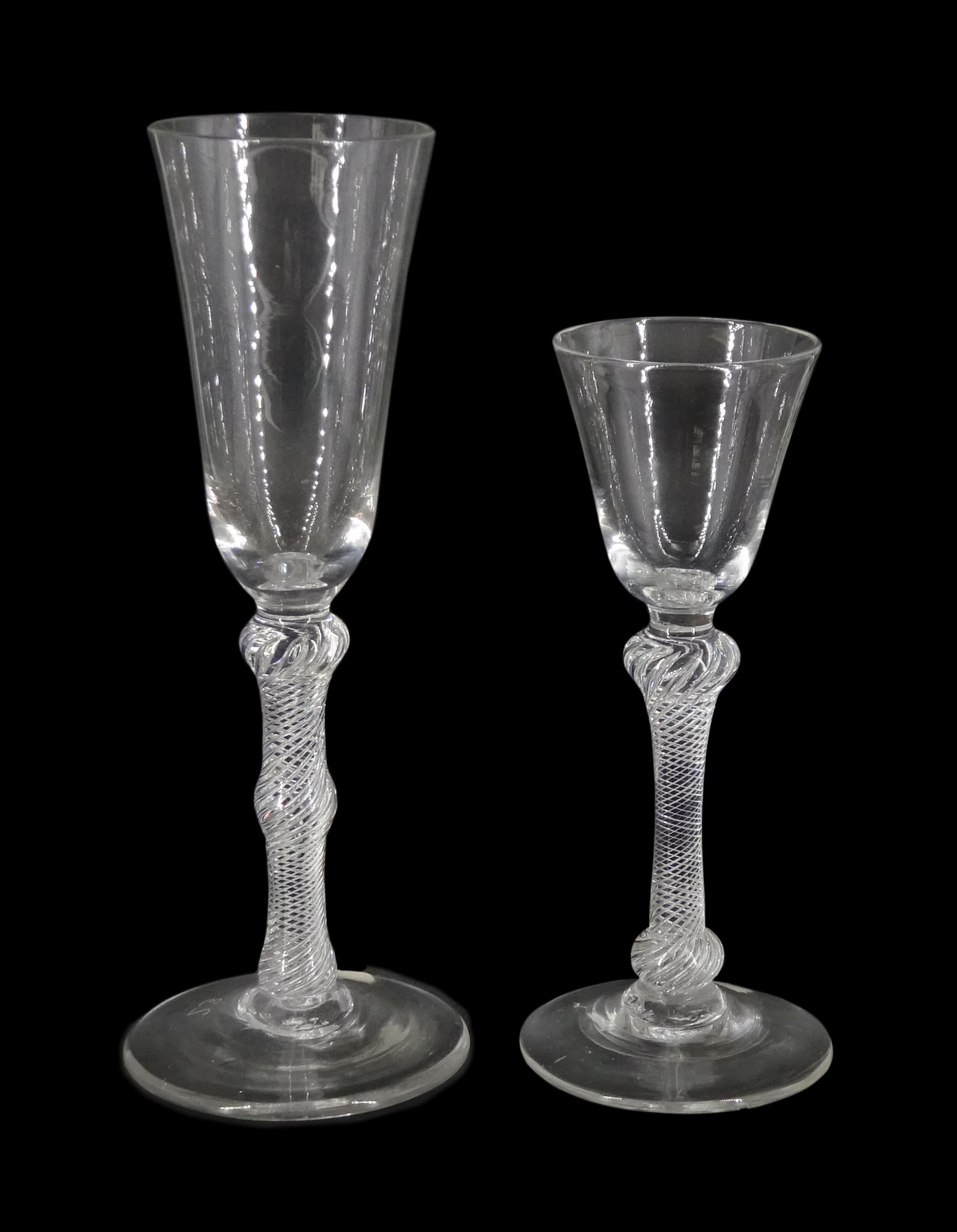 18th century ale glass, the funnel bowl raised upon a single series air twist double knopped stem and conical foot, H20cm, together with a similar smaller drinking glass, H15.5cm