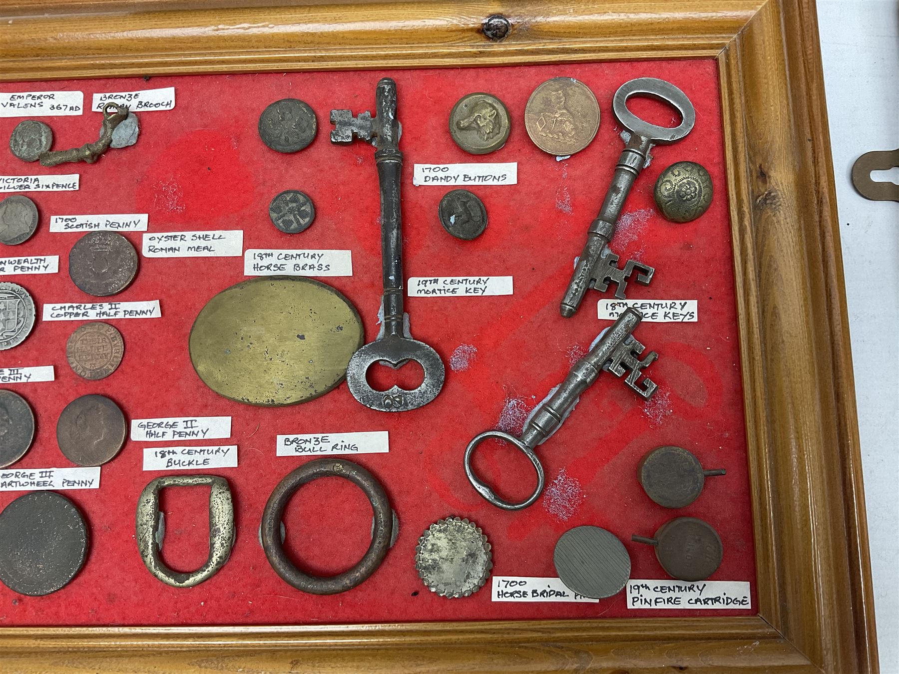Collection of metal detecting finds and antiquities, housed on five display boards and some loose, to include coins, keys, axe head etc 