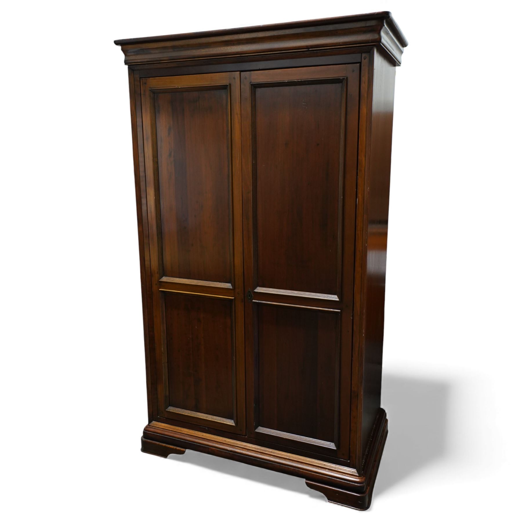 Willis & Gambier - French cherry wood double wardrobe, panelled front twin doors, internal wooden hanging rail below a shelf, raised on a moulded plinth base 