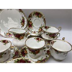 Royal Albert Old Country Roses pattern part tea service, comprising ten teacups, twelve saucers, twelve side plates, milk jug, open sucrier, cake plate and other dishes, together with Royal Albert coffee pot decorated with rose sprays above pale pink band