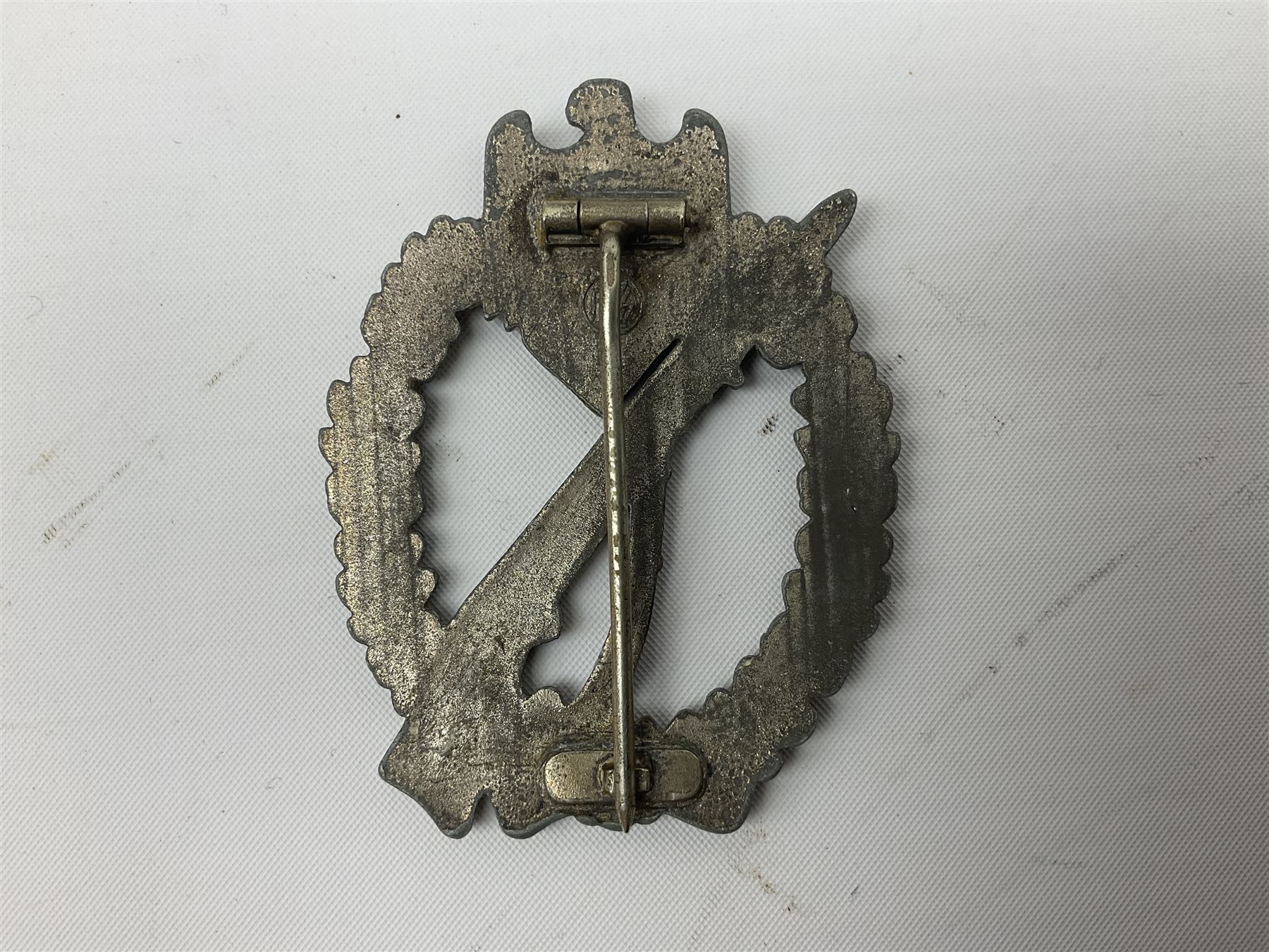 Three WW2 German badges comprising Blockade Runner War Badge and Coastal Artillery badge, both marked 'Fec Otto Placzec Berlin'; and Infantry Assault Badge; all with fixing pins (3)