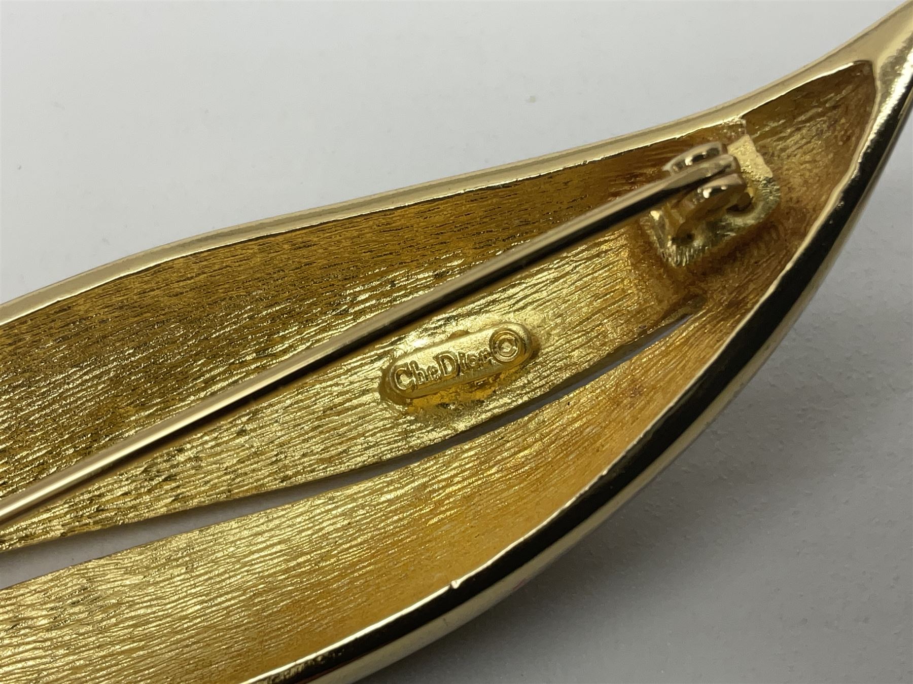 Christian Dior costume jewellery, comprising pair of pearlescent clip on earrings, enamel and paste leaf brooch and a pierced stylised leaf brooch, each stamped Chr.Dior Germany and in original boxes