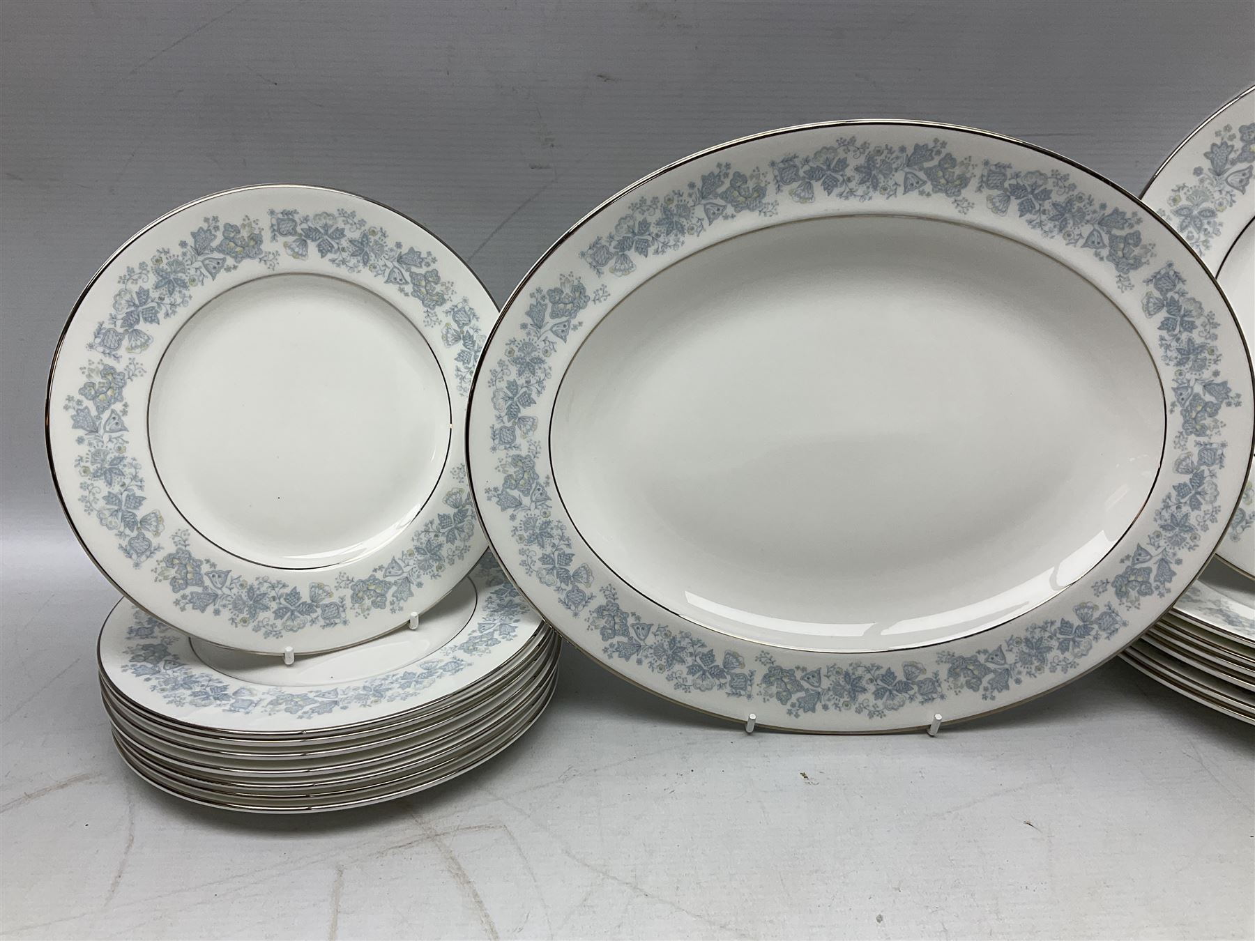 Royal Doulton tea and dinner wares in the Meadow Mist pattern, no H5007, comprising seven dinner plates, eight side plates, two lidded tureens, two jugs, lidded sucrier, oval serving dish, six teacups, seven saucers, seven tea plates and large saucer