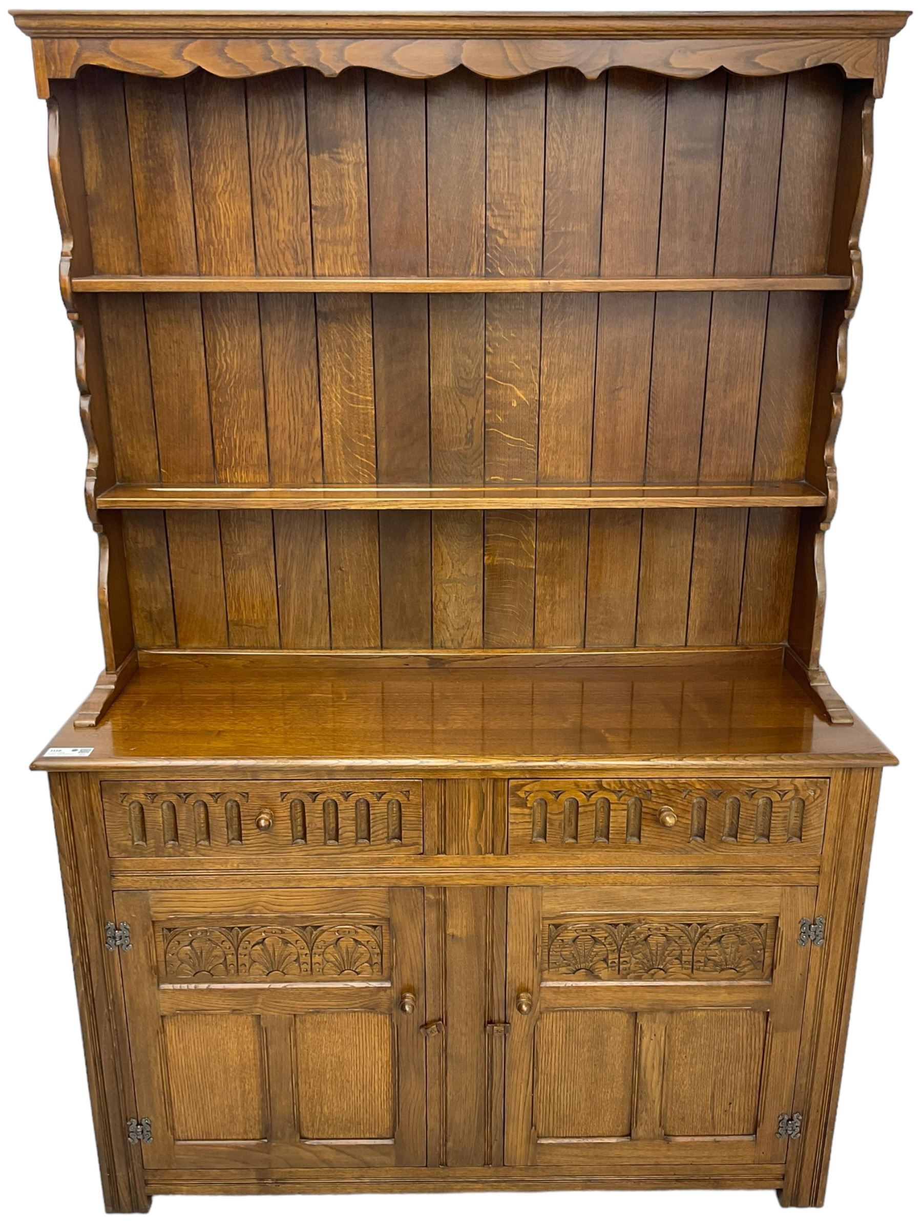 Mid-20th century oak dresser, raised two heights plate rack over two drawers and two cupboards