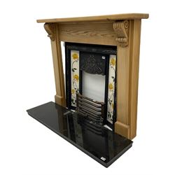 Complete fireplace - pine surround with ornate cast iron inset with Art Nouveau style floral tiles, granite hearth, brass fender and optional gas fire fitting