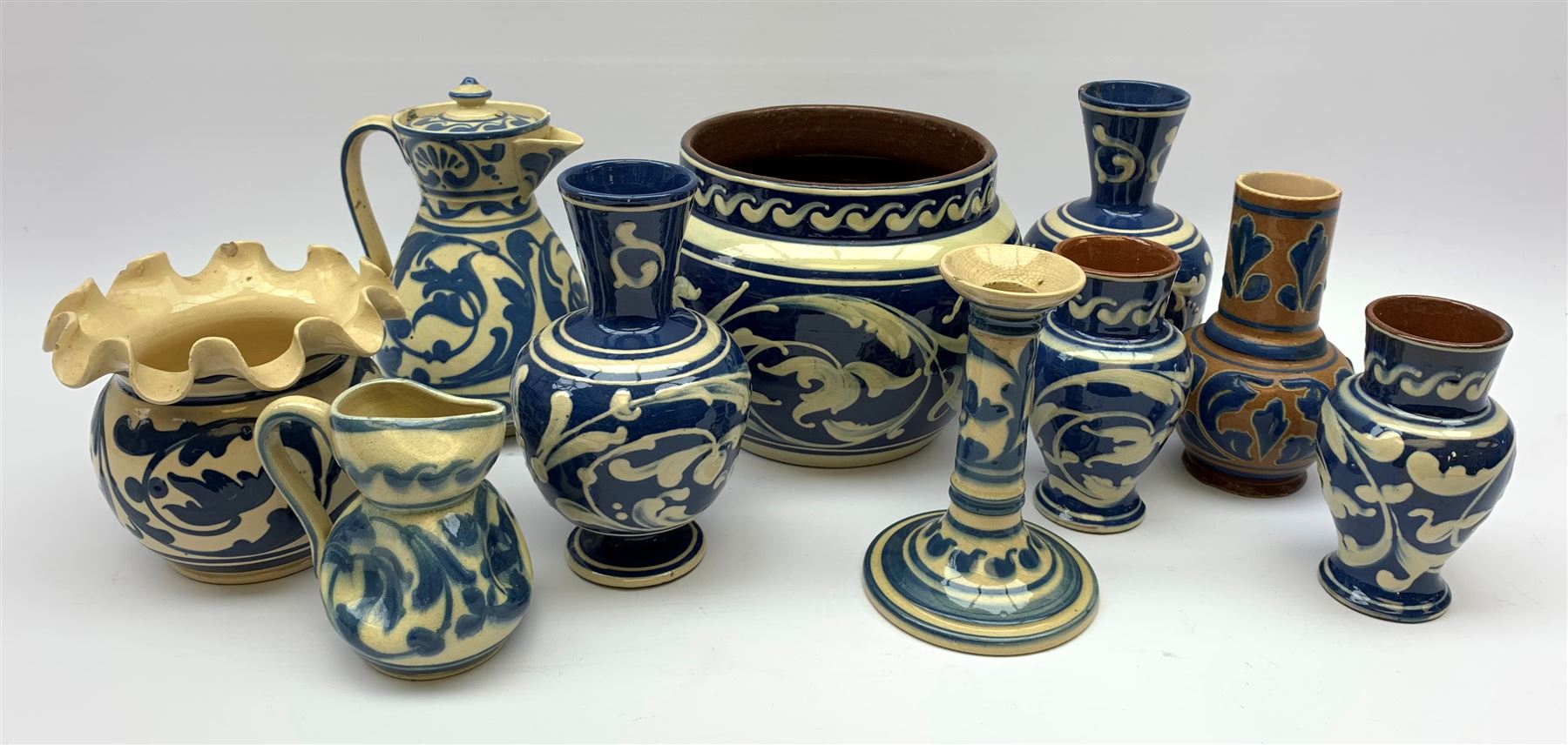 South Devon slip glazed pottery comprising: Aller Vale pottery bottle vase, Aller Vale candlestick, Exeter vase, jardinière, hot water pot and other similar pieces 