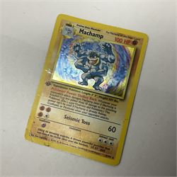 Collection of Pokemon trading cards, mostly 1999 Wizards Pokemon cards to include holo Charizard 4/102, first edition holo Machamp 8/102, further holographic cards; Dark Flareon 35/82 and Dark Vaporeon 45/82, cards from themed sets and 4th edition prints; 1998 Electronic Pokédex with cardboard boxes for themed decks Blackout, Overgrowth and Power Reserve Jungle, along with a large quantity of energy and trainer cards 