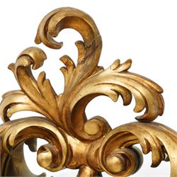 Rococo design carved gilt wood wall mirror, shaped and moulded frame decorated with scrolling leafage, plain mirror plate divided by mouldings