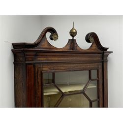George III oak floor standing corner cabinet, scrolled swan neck pediment with central finial over astragal glazed door, painted interior fitted with three shaped shelves, the lower section fitted with single shaped shelf enclosed by two fielded panel doors inlaid lozenges, on bracket feet, H195cm, W77cm