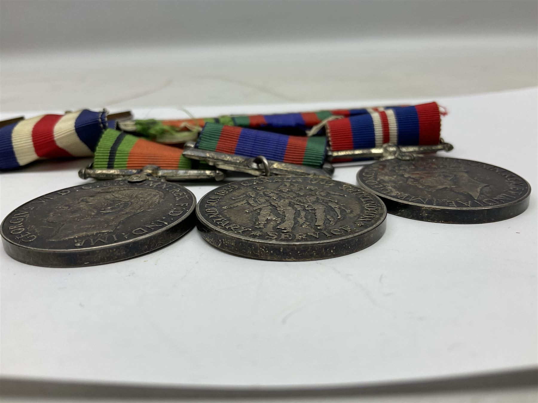 WW2 group of five medals comprising 1939-1945 War Medal, Defence Medal, 1939-1945 Star, France and Germany Star and Canadian Volunteer Service Medal; on wearing bar with ribbons; with a medal box and slip and three photographs