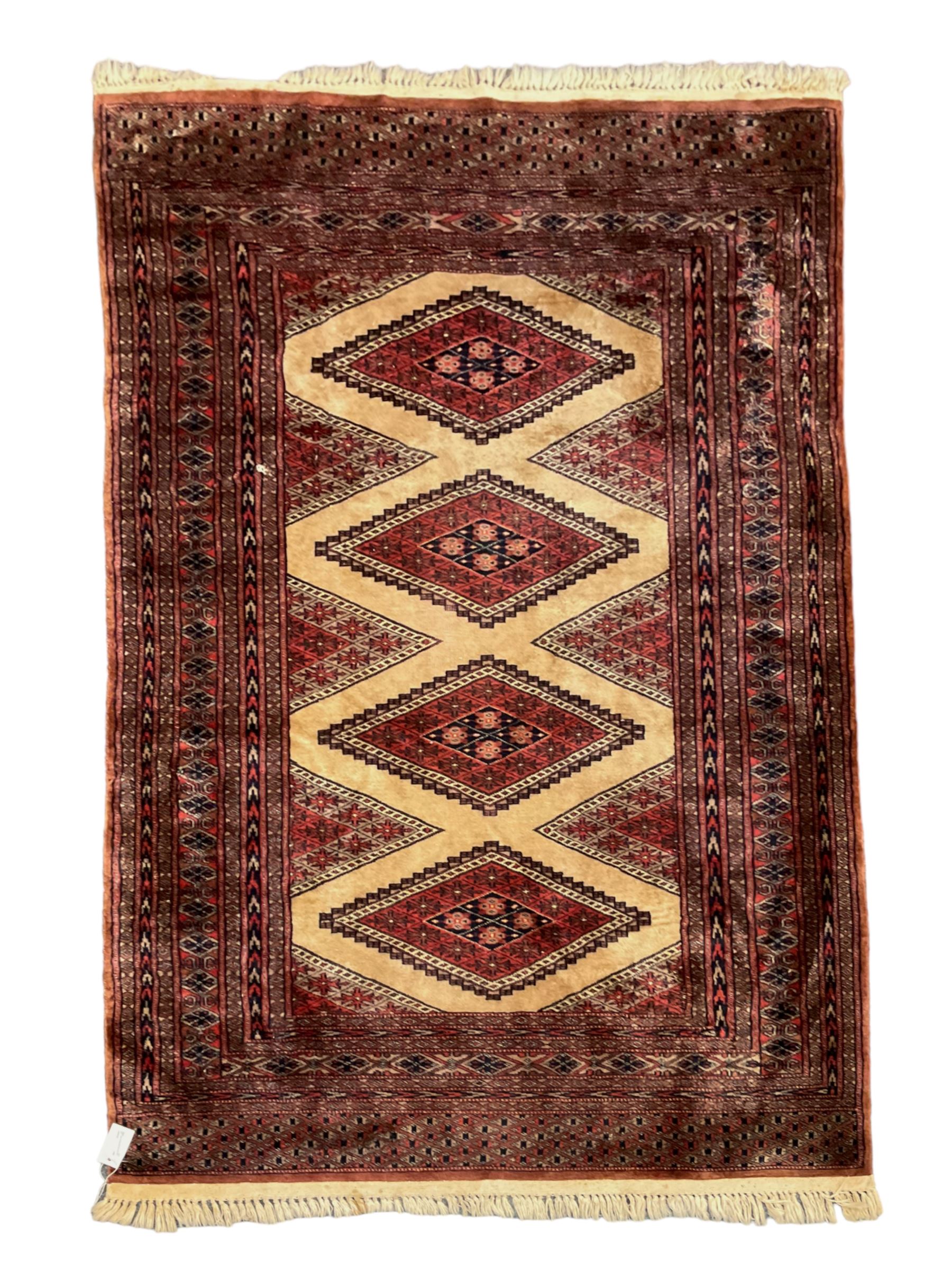 Persian rug, the interconnecting field decorated with four lozenge medallions, multiple band border with overall geometric design decorated with stylised flower head motifs