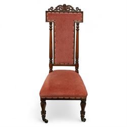 Victorian walnut high back hall chair, with pierced and scrolled crested rail above a rectangular back and seat upholstered in plush cerise fabric, flanked by tulip carved and turned uprights raised on turned and tapered front legs  