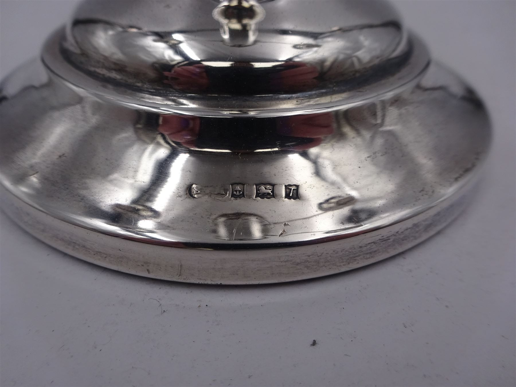 Modern silver mounted three branch candelabra, the tapering stem supporting a central candle holder and two removable curved branches with candle holders, upon spreading circular foot, hallmarked Birmingham 1968, maker's mark worn and indistinct, H25.5cm