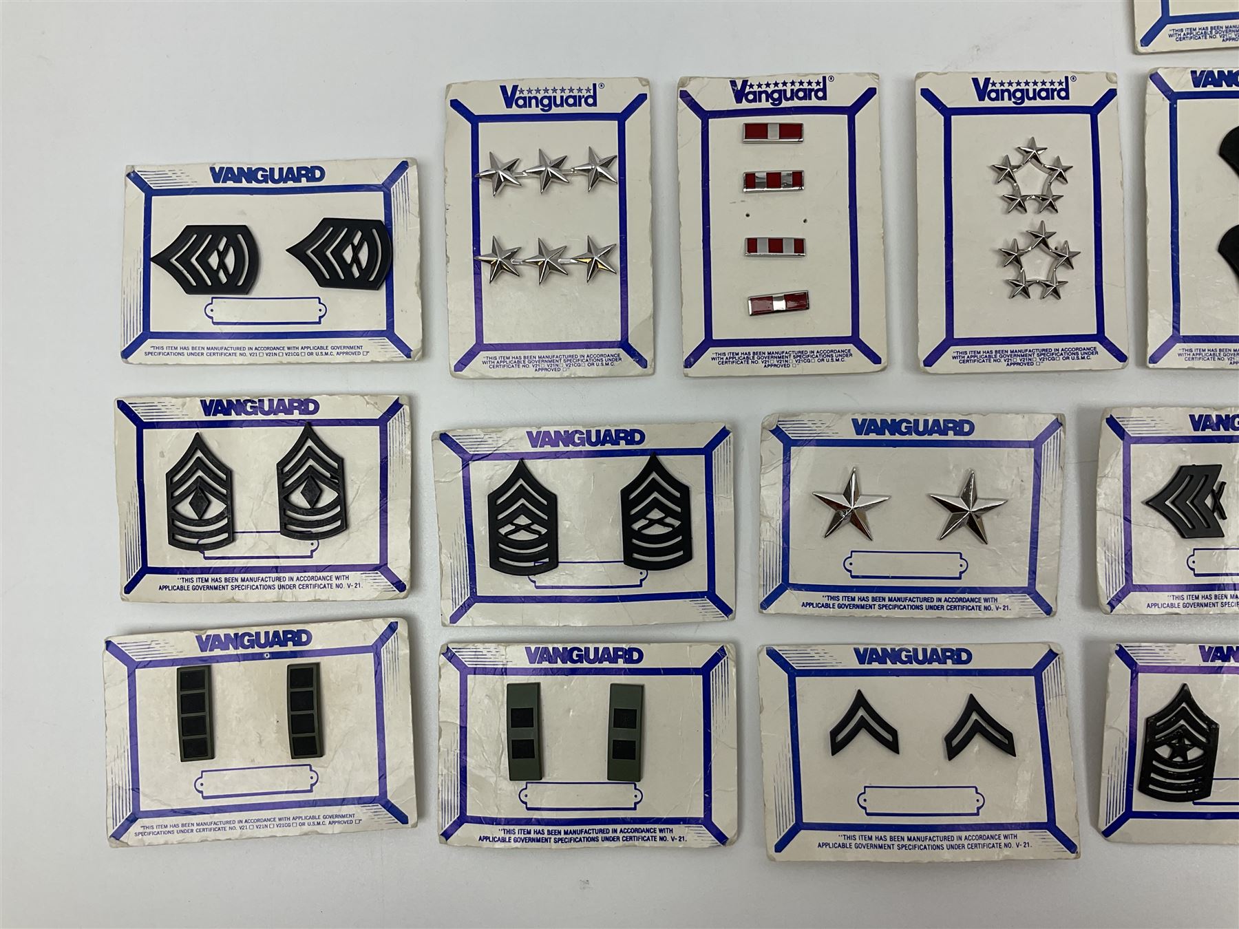 Fifty US rank badges and trade badges; WW2 and Vietnam period; predominantly on sale cards