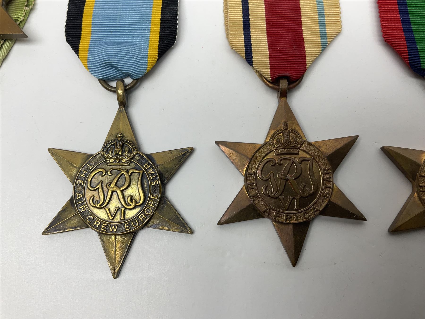 Representative display of WWII Campaign stars comprising 1939-1945 Star, Atlantic Star, Air-Crew Europe Star, Africa Star and Pacific Star; together with the corresponding group of miniatures; all with ribbons
