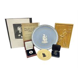 Group of William Wilberforce Abolition of Slavery items, comprising Wedgwood black on cane Jasperware pin tray, Wedgwood light blue Jasperware plate, and two Wedgwood oval medallion pendants, each depicting a kneeling figure beneath the inscription 'AM I NOT A MAN AND A BROTHER?', an Eastgate pottery plaque decorated in relief with a kneeling figure before William Wilberforce, a Hull Museum Publications pamphlet titled 'Medals, Tokens, etc., Issued in Connection with William Wilberforce and the Abolition of Slavery', by Thomas Sheppard, dated 1916, and an antique print depicting William Wilberforce after the original portrait by George Richmond, (7)