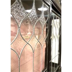 Late 19th century mahogany Empire style display cabinet, swan neck pediment and carved urn finial over two lead glazed doors enclosing two shelves, two glazed doors under, raised on cabriole front supports