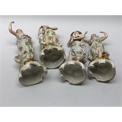 A group of five Continental figurines modelled as the arts, emblematic of music, painting, sculpture, literature, and theatre, each with spurious blue cross mark beneath, H22.5cm. (5). 
