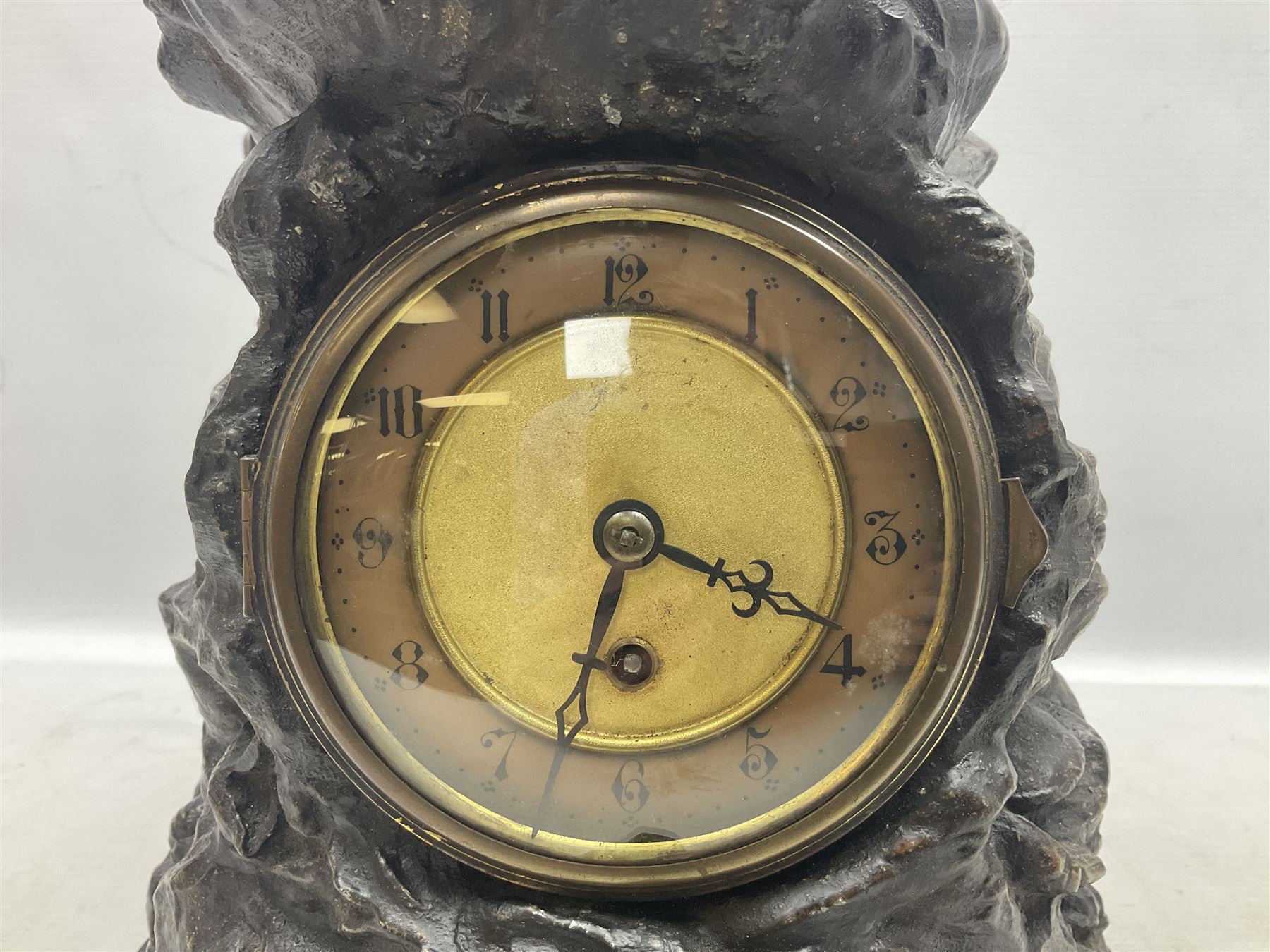 Early 20th century spelter effect figure of a sailor standing in the bow of a boat scanning the horizon, on a simulated rock base with a plaque entitled 'Rescue', base fitted with a timepiece clock movement and two-part dial, with pierced hands, gilt dial centre and ivorene chapter ring written in Arabic numerals, German HAC spring driven going barrel movement wound from the front; with pendulum H65.5cm
