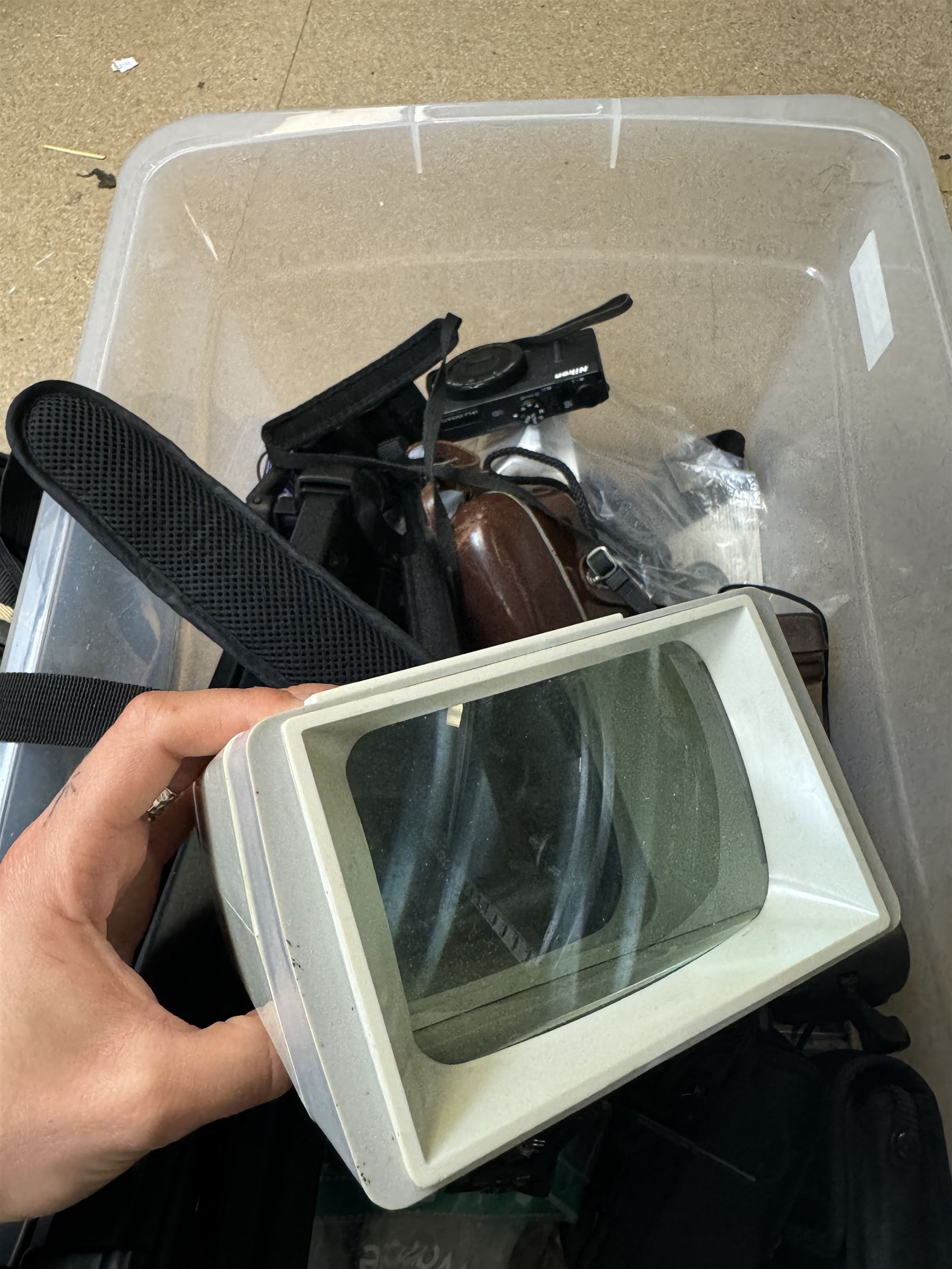 Collection of cameras and camera equipment, including Voigtlander Vitomatic I, Nikon Coolpix P340, Nikon Coolpix S9100, Olympus SP-510UZ, tripod, cases, etc