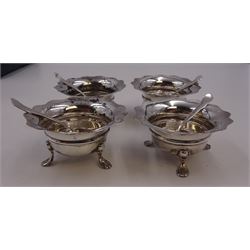 Set of four Edwardian silver open salts, of circular form, each with later personal engraving to scalloped rim and upon three pad feet, together with four matching silver salt spoons, hallmarked James Deakin & Sons, Sheffield 1909, in velvet and silk lined fitted case     