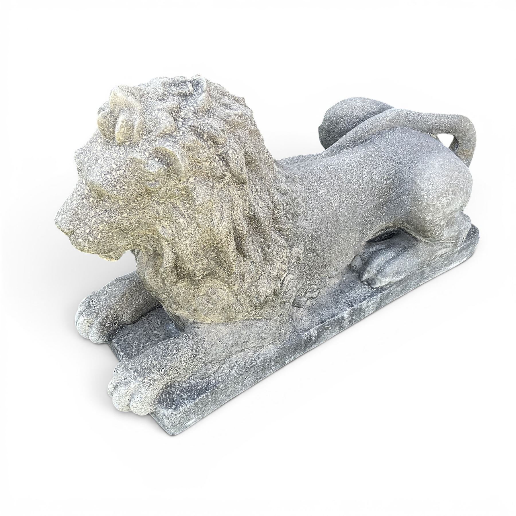 Pair of large cast stone recumbent garden male lions, modelled with flowing manes and raised heads with closed jaws, on rectangular plinth bases