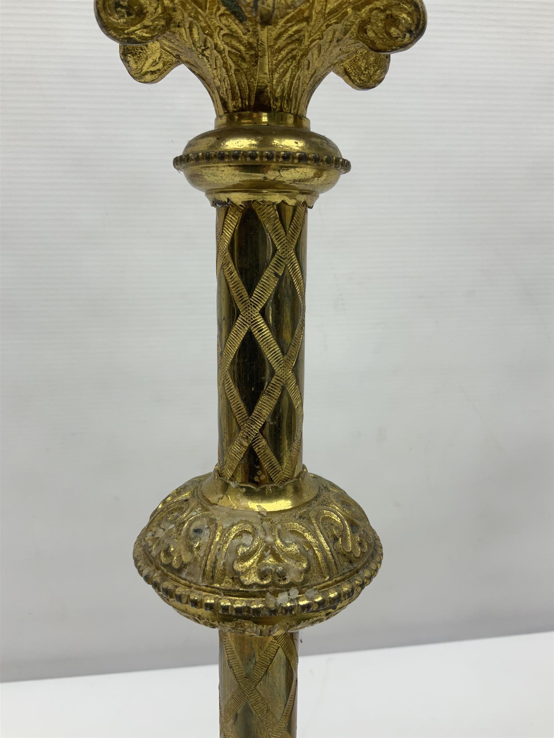 Pair of gilt metal pricket candlesticks, with applied decoration on knopt stems and triform bases, H47cm