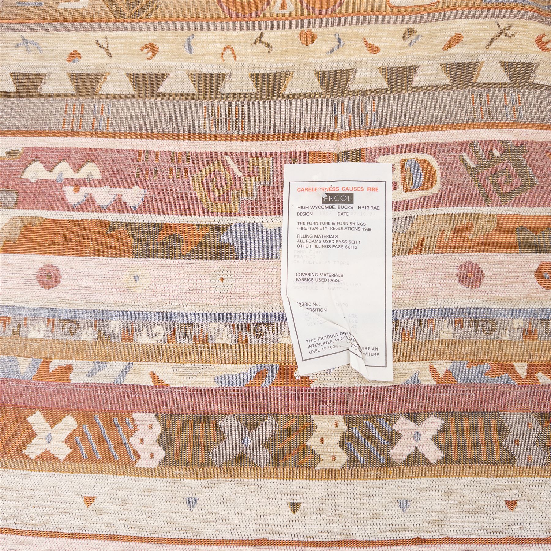 Ercol - Renaissance ash and elm high back armchair, upholstered in geometric Kilim patterned fabric with padded back, seat and arm cushions, curved stick back frame and turned supports