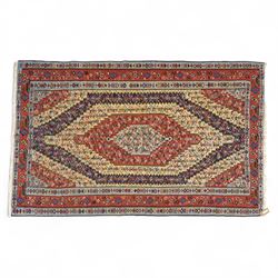 North West Persian Senneh kilim, finely woven wool with elongated central lozenge medallion on a densely patterned field of boteh motifs, in tones of red, ivory, indigo and ochre, framed by floral and diamond guard borders