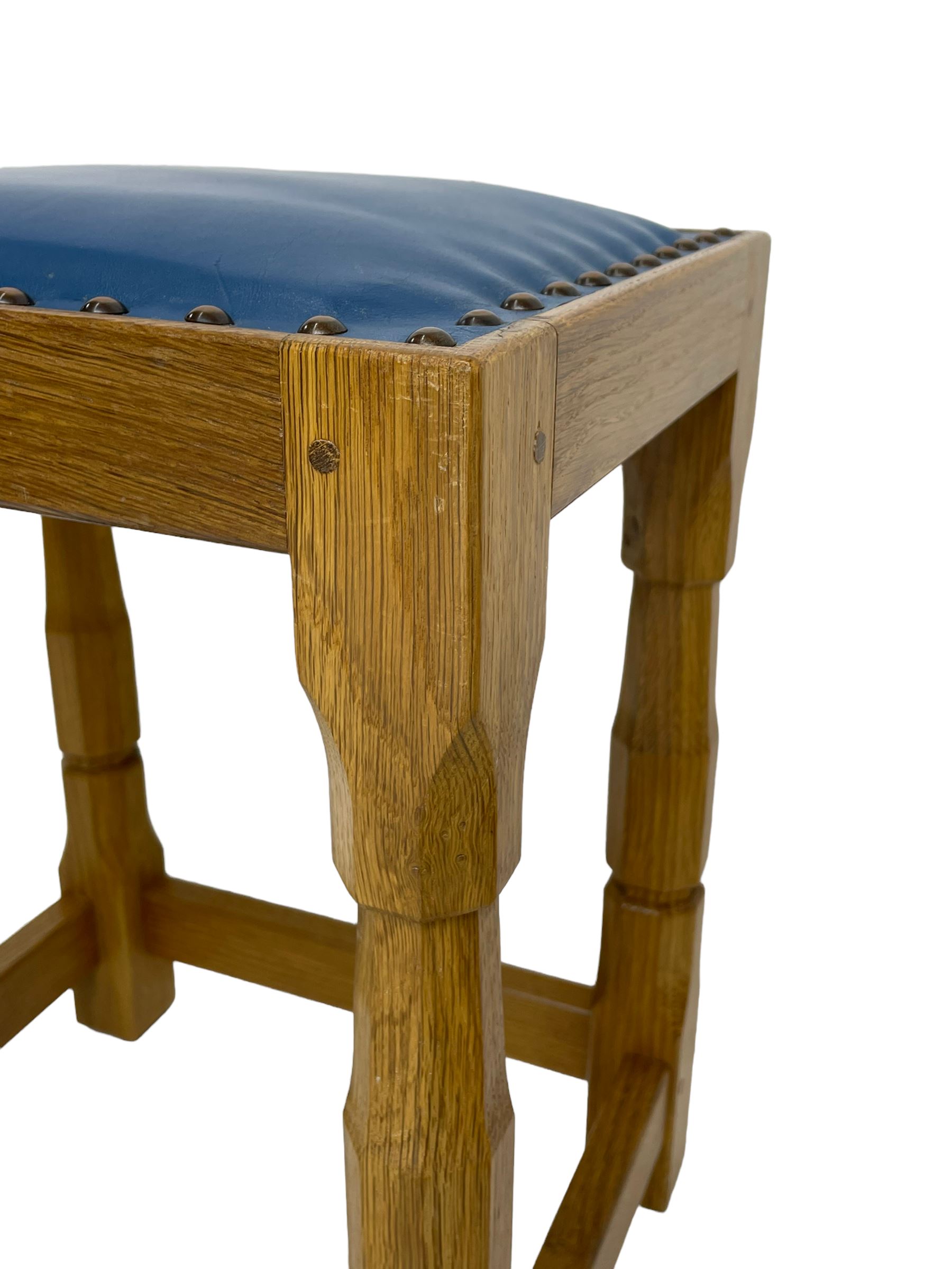 Brian Haw (former Mouseman carver) - Yorkshire oak stool, blue leather upholstered seat with stud band, on octagonal supports joined by plain stretchers
